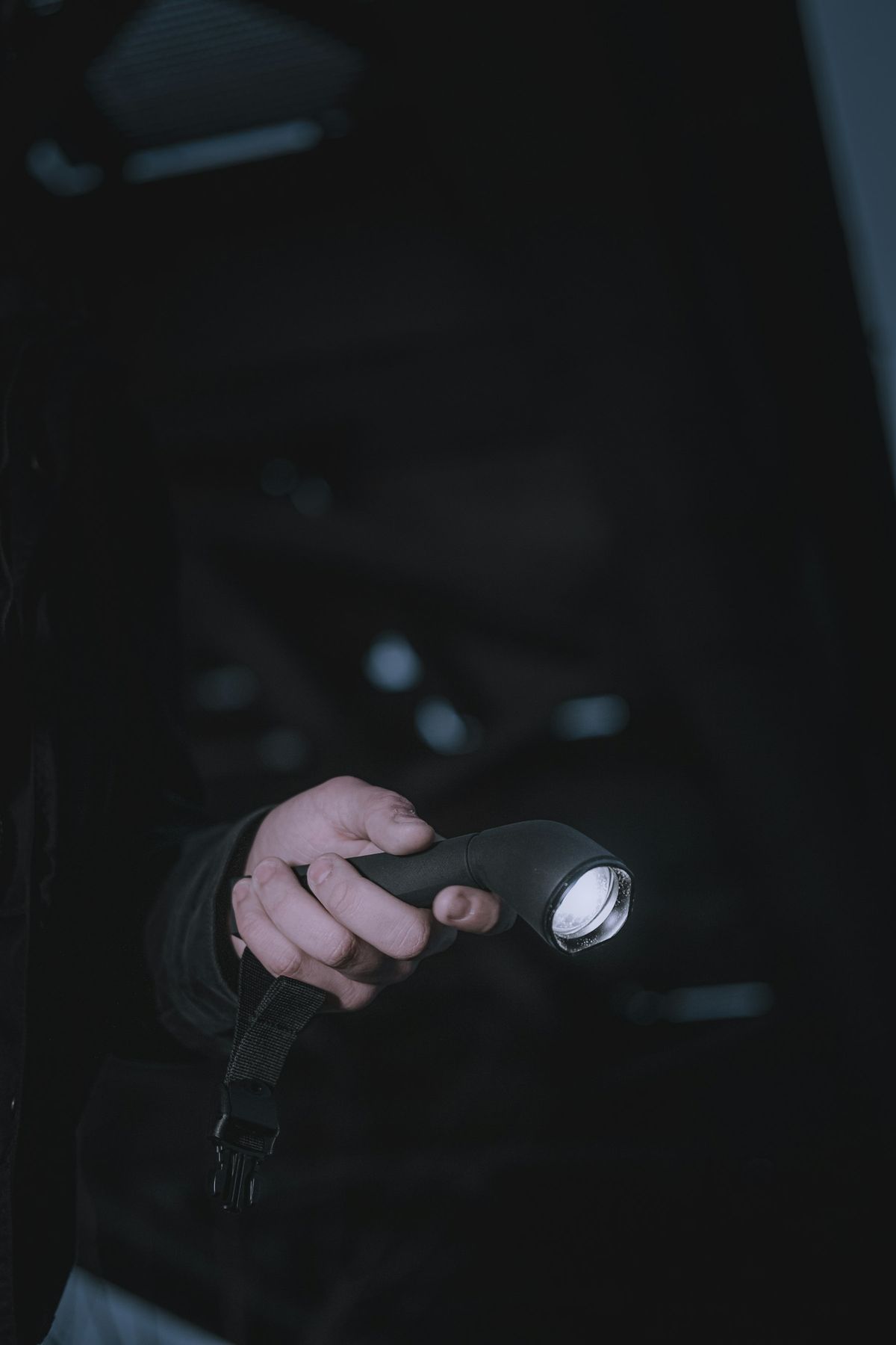 Security officer holding a torch at night